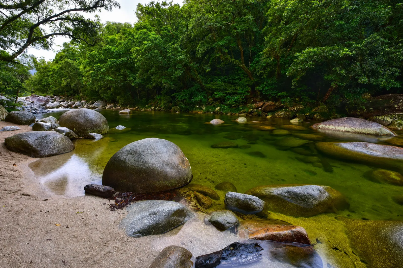 Clear green pool among granite boulders at Mossman Gorge