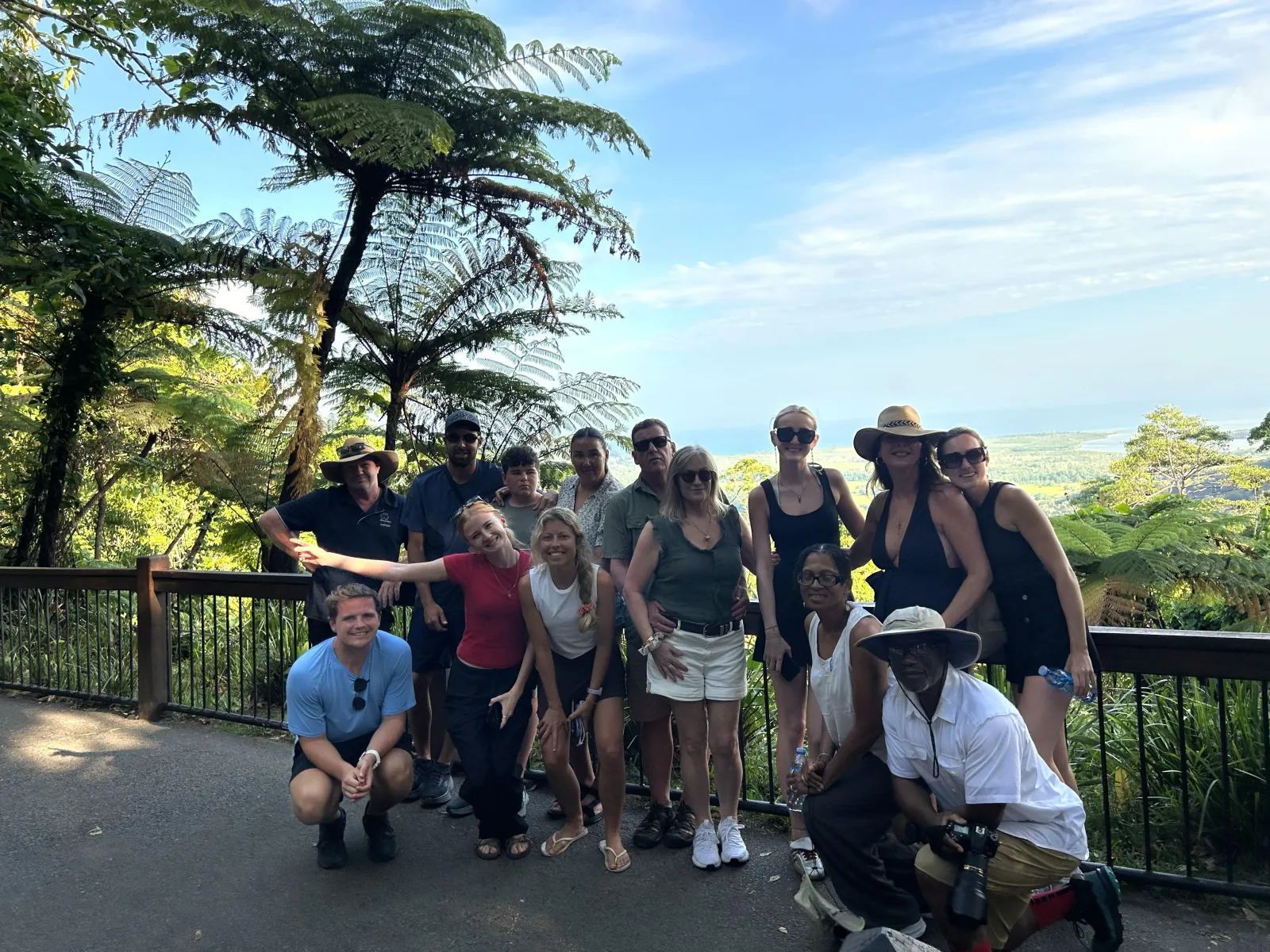 Small tour group posing at a rainforest lookout