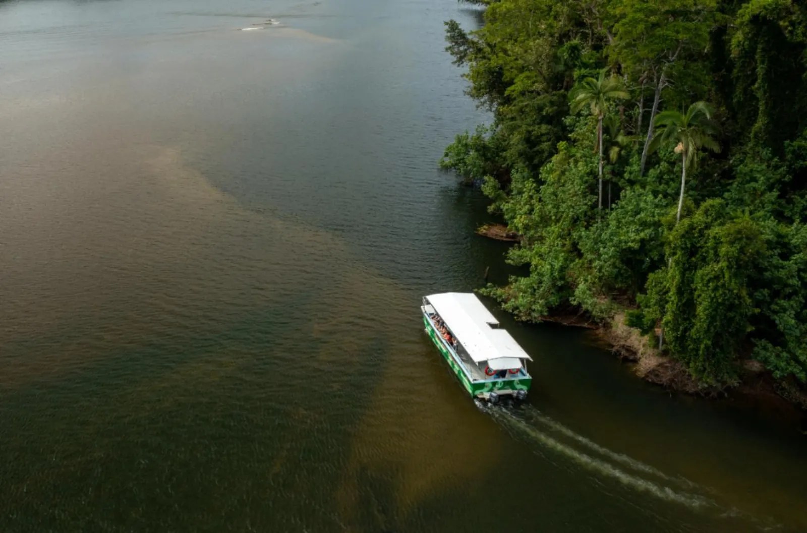 River cruise boat on the dark water of the Daintree River