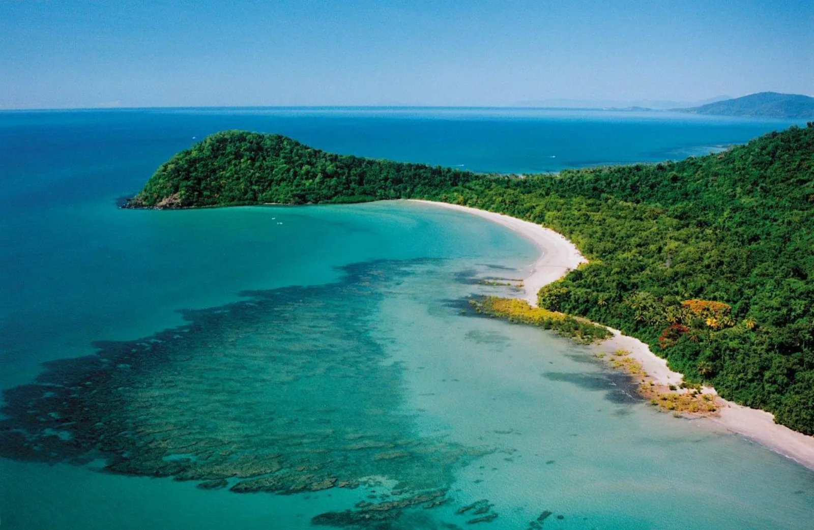 Aerial view of Cape Tribulation headland, beach and fringing reef