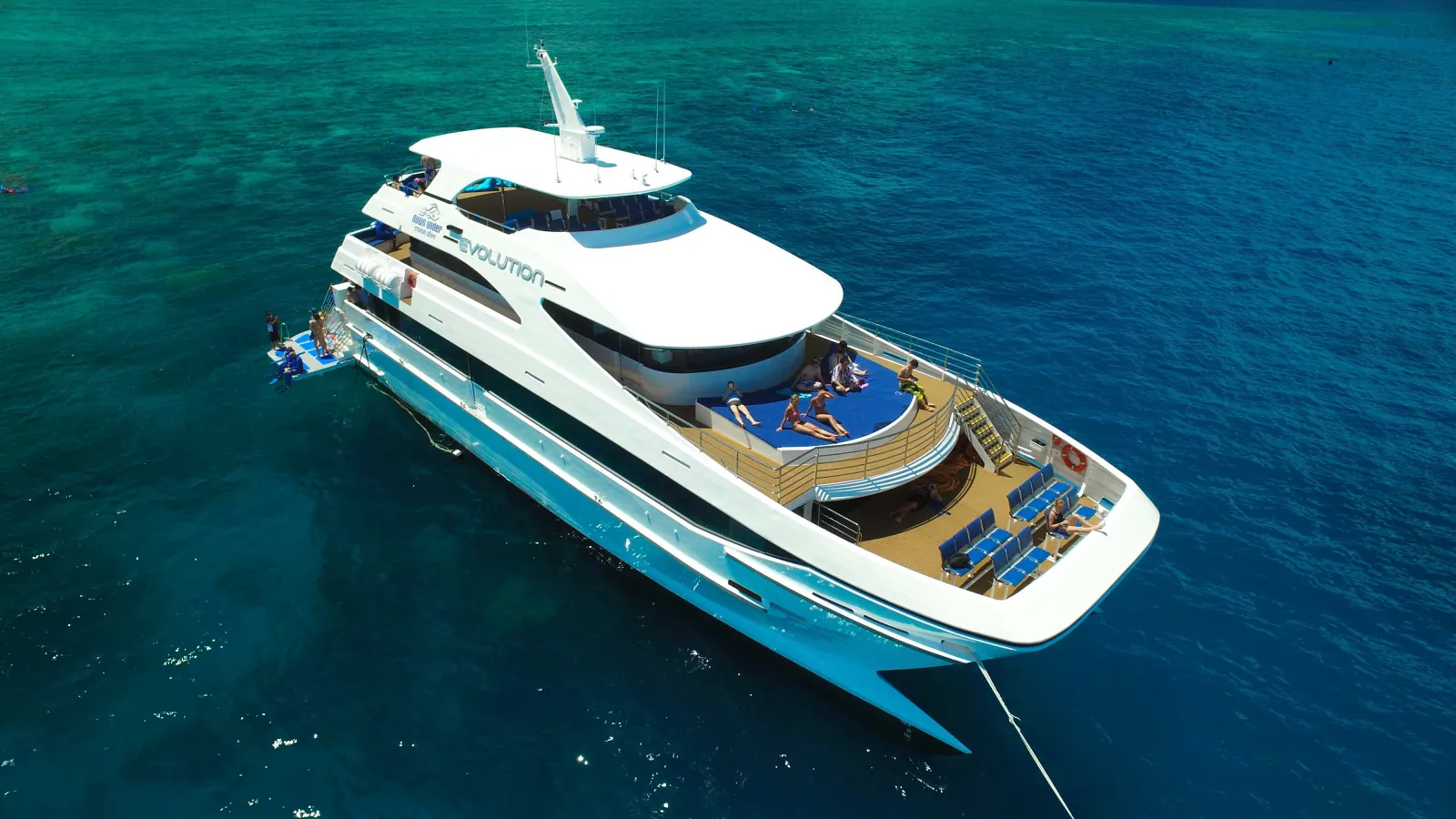 Reef cruise boat anchored over deep blue water