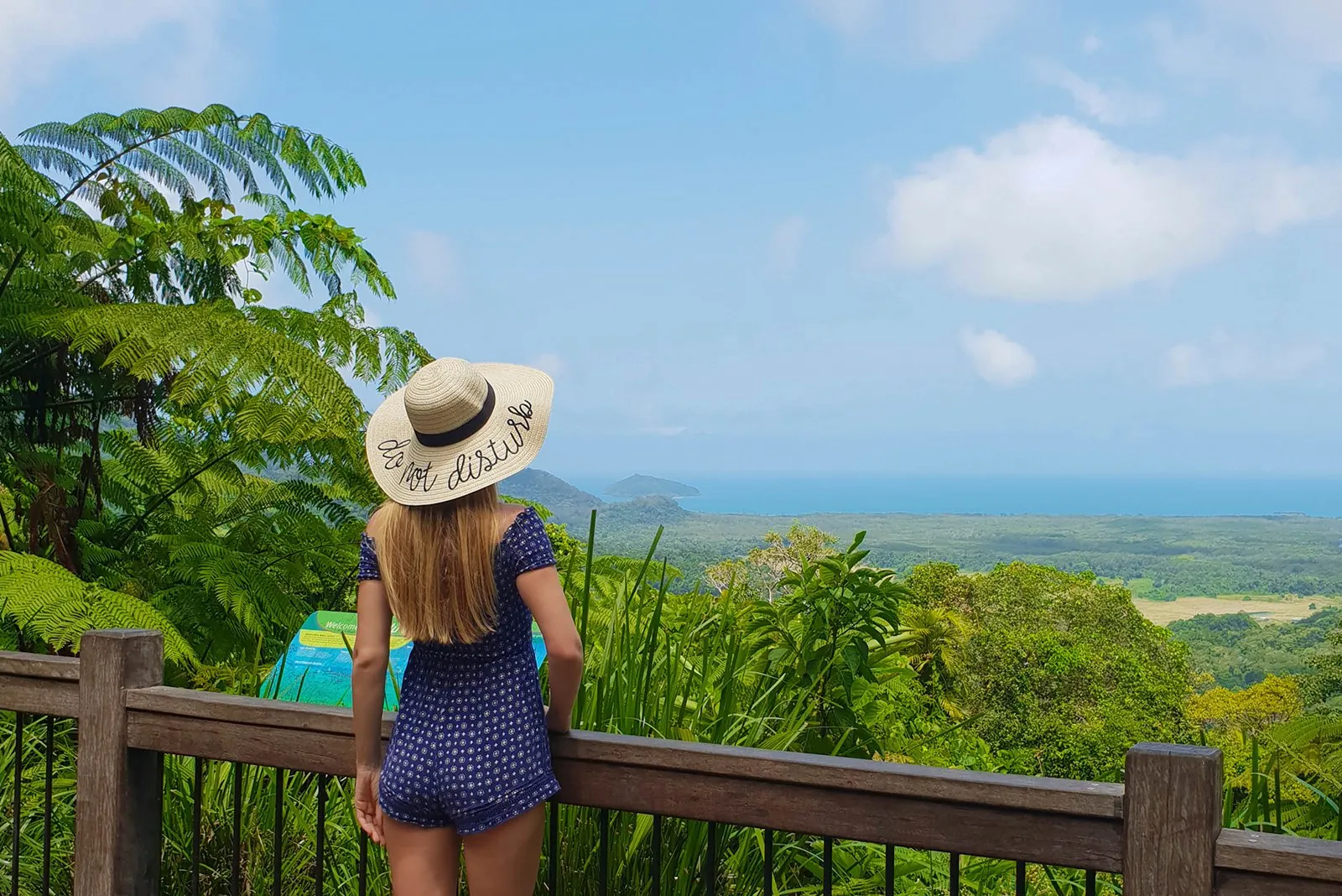Visitor in a sun hat at a lookout over the Daintree lowlands