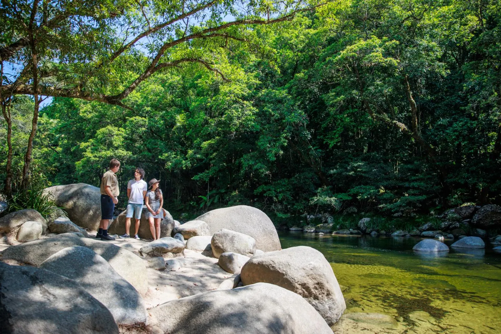 Visitors on granite boulders beside the river at Mossman Gorge