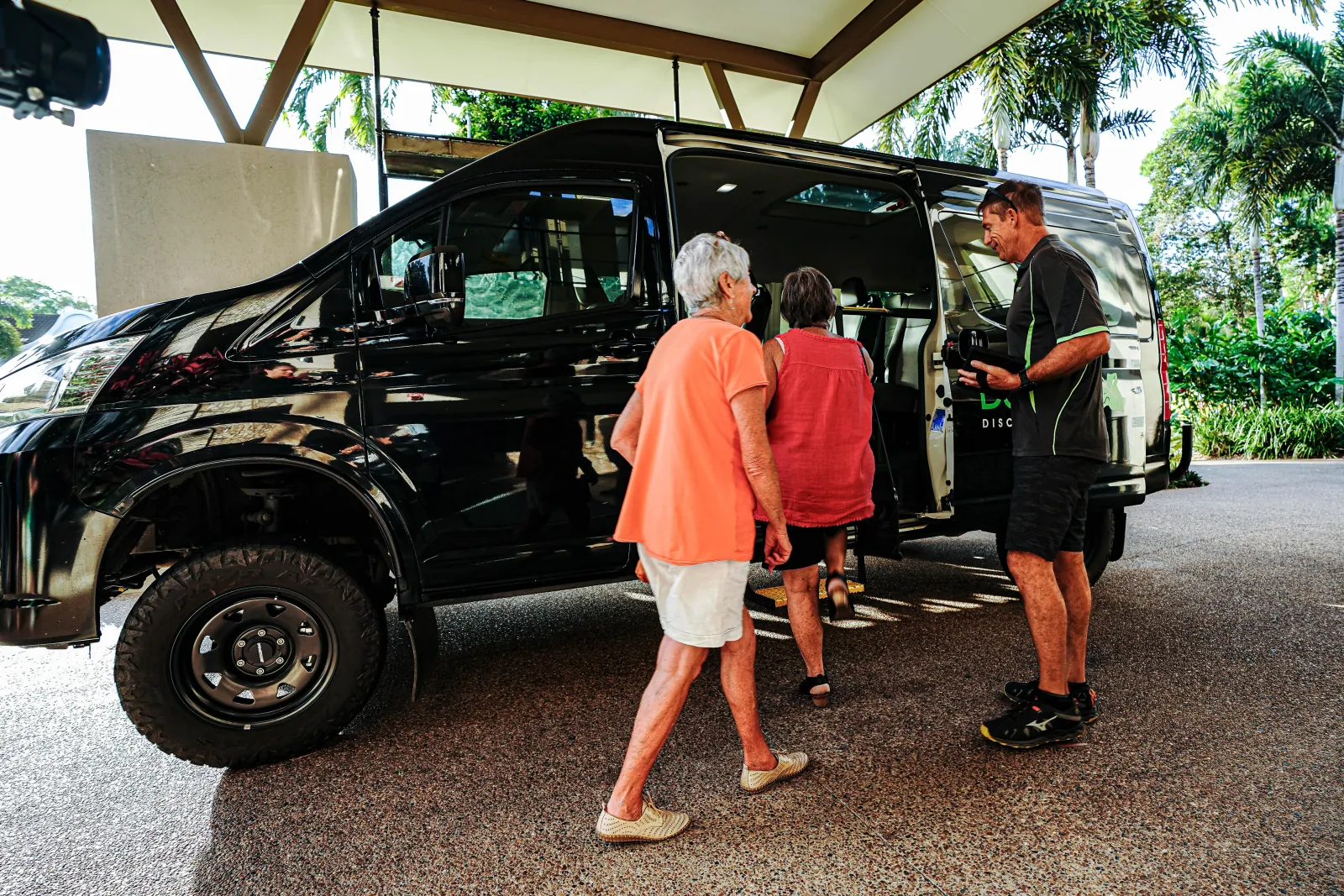 Guests boarding a tour vehicle