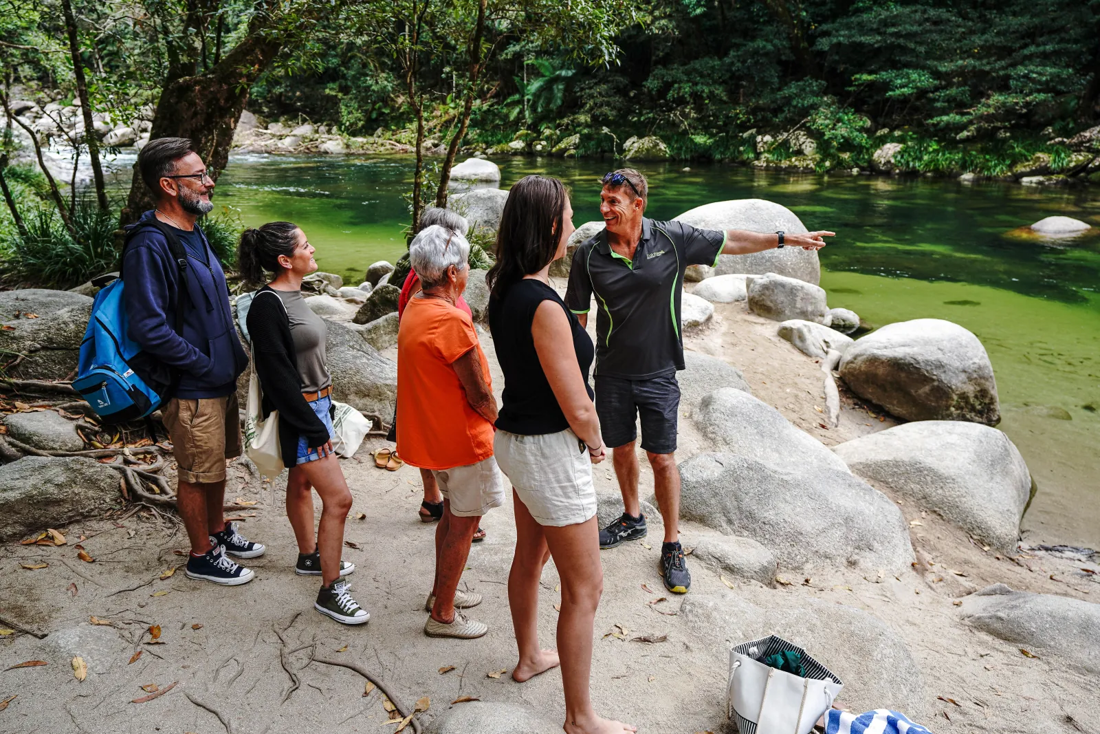 Guide talking to guests on the rocks at Mossman Gorge
