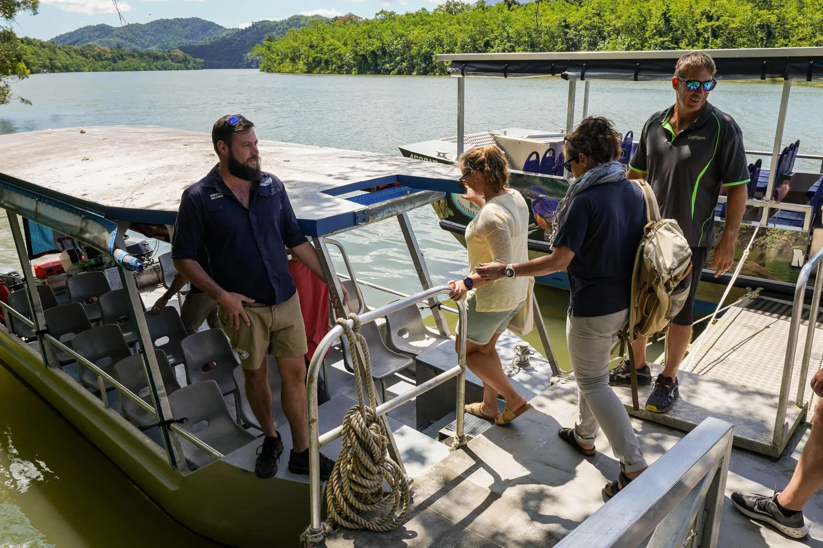 Guests stepping aboard a river cruise boat