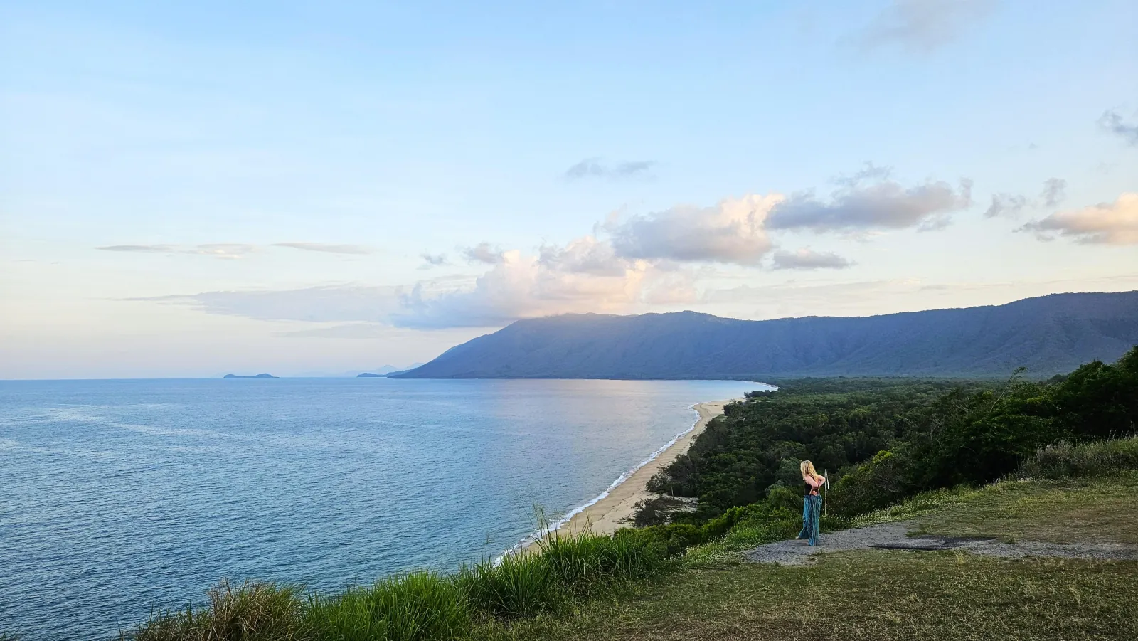 Visitor at a coastal lookout at sunset on the road north